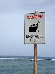a photo of a sign saying: danger, unstable cliff